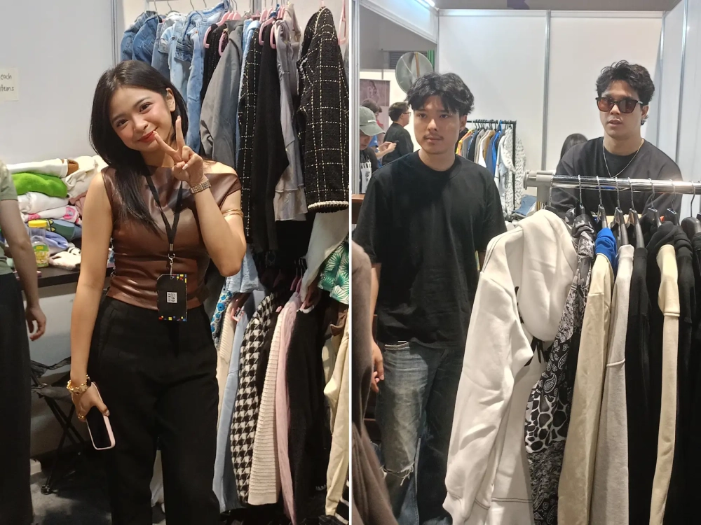 Young creators and attendees posing in front of clothing racks at a fashion and apparel pop-up booth inside a convention center.